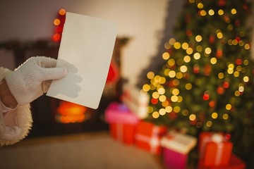 Hand of santa showing a paper