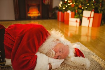 Obraz premium Father christmas sleeping on the rug