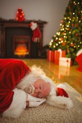 Obraz premium Santa claus napping on the rug