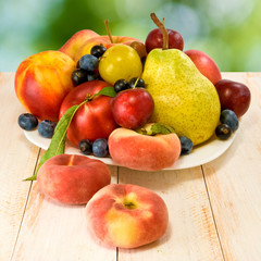 different fruits on green background