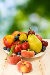 image of various fruits on a table on green background