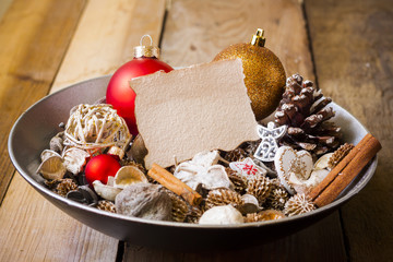 Blank greeting card with christmas decorations in dish