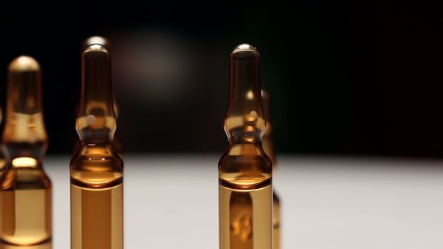 Ampoules containing pharmaceutical products,rotating.