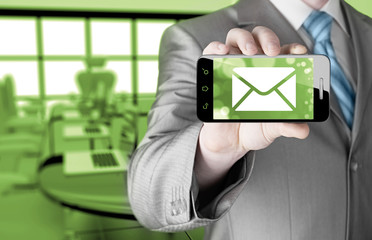 A man holding smartphone with one new message on a screen.