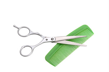 .scissors for cutting and green plastic comb
