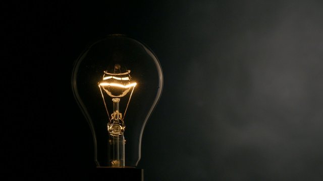 Light bulb over black background