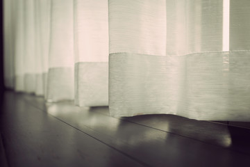 White curtain beside window