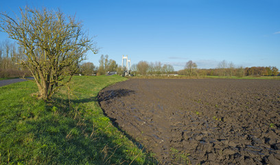 Fototapeta na wymiar A plowed field under a sunny sky at fall