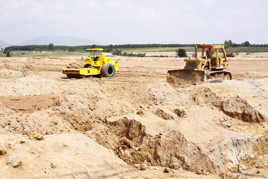 Bulldozer and Soil Compactor at Construction Site