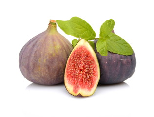 Three sliced figs with mint isolated on white background