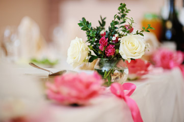 bouquet of flowers in a vase on the table. Wedding decor
