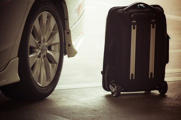 suitcase near a taxi