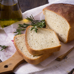 Bread with rosemary and olive oil on a wooden table