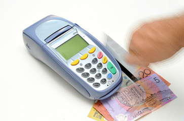 EFTPOS machine with credit cards and Australian money.