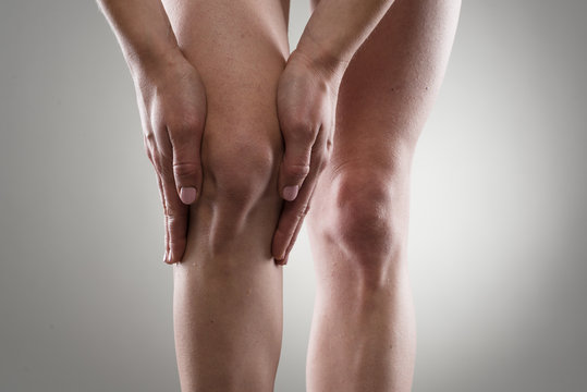 Woman touching her injured knee. Rheumatism or arthrosis.
