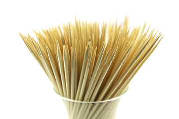 pile of wooden bamboo skewers on white background