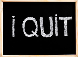 I quit message, handwriting with chalk on blackboard