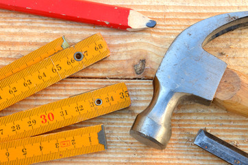 Claw hammer, carpenter meter, pencil and chisel