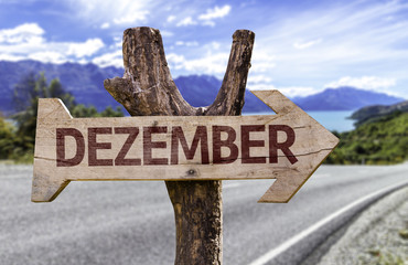 December (In German) sign with a road background
