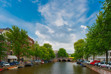 Fototapeta na wymiar City view of Amsterdam canal, bridge and boats, Holland, Netherl