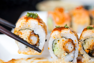 Sushi roll with black chopsticks
