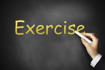 hand writing exercise on black chalkboard