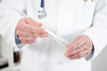 Doctor holding a medical thermometer