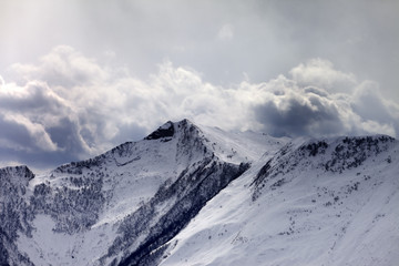 Mountains in evening cloudy sky