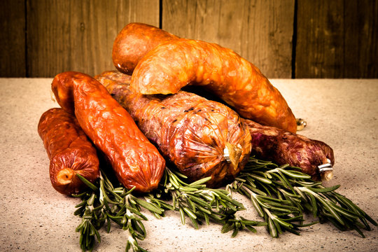 several types of sausages on a light background