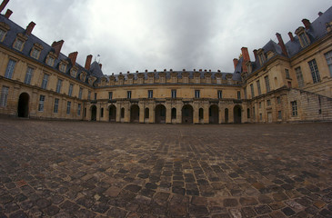 Fototapeta na wymiar Cobbled courtyard of the palace of Fontainebleau in France