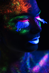 Sensual woman in fluorescent paint makeup. Close up