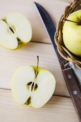 yellow wet fresh apples in a wicker basket
