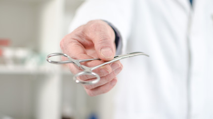 Doctor holding a clamp