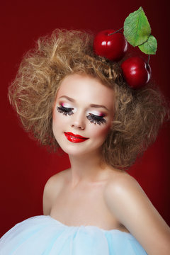 Grotesque. Humorous Woman with Red Apples and Fancy Makeup