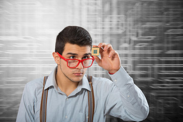 Man looking at the microprocessor in his hand