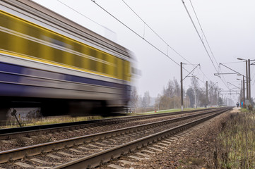 Electric passenger train traveling on the railroad tracks
