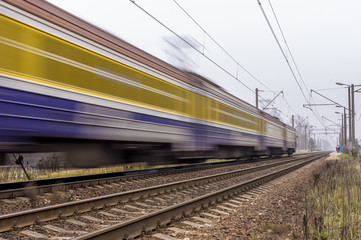 Fototapeta premium Electric passenger train traveling on the railroad tracks