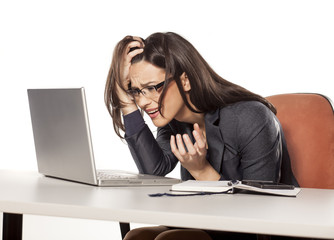 shocked young businesswoman looking in her laptop