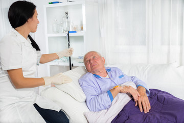 Fototapeta premium doctor or nurse includes infusion patient in hospital