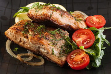 Fried salmon steak with vegetables