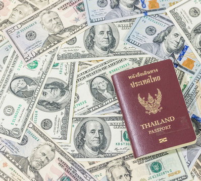 Group of banknote in US currency and Thai passport