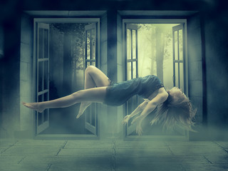 Levitating young woman in her house