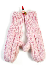 Pink knitted mittens on clothespin-snowman