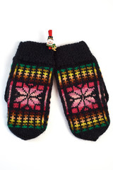 Pink knitted mittens on clothespin-snowman
