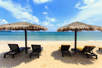 Sun umbrella and sun loungers stand at the beach in Phuket, Thai