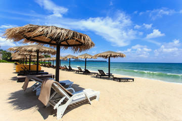 Sun umbrella and sun loungers stand at the beach in Phuket, Thai