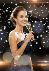 smiling woman holding glass of sparkling wine