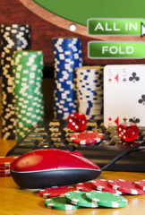 Online gambling closeup of mouse chips cards and computer screen