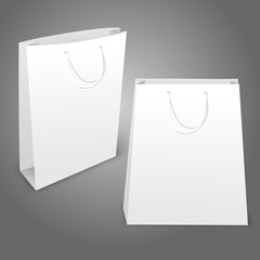 Two realistic white blank paper bags. Isolated on grey