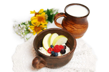 Milk and curd with summer fruits in ceramic bowls